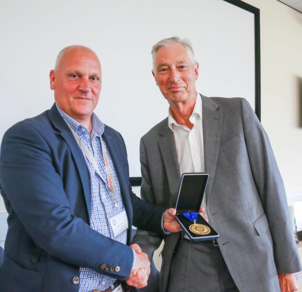 Dr Graham Rogers (right) receiving the Harry Leck memorial award from Dr Andrew Chew