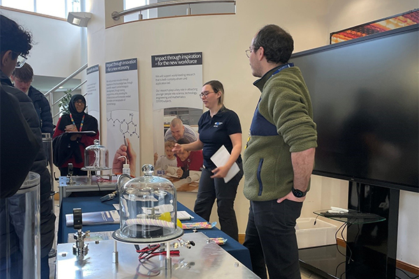 A group of people explaining experiments.