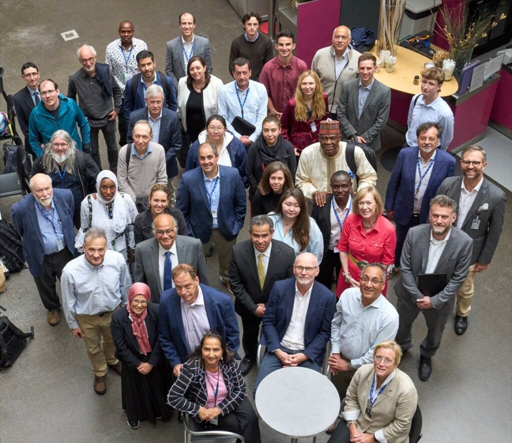 A group of people posing for a picture, looking upwards into the camera.