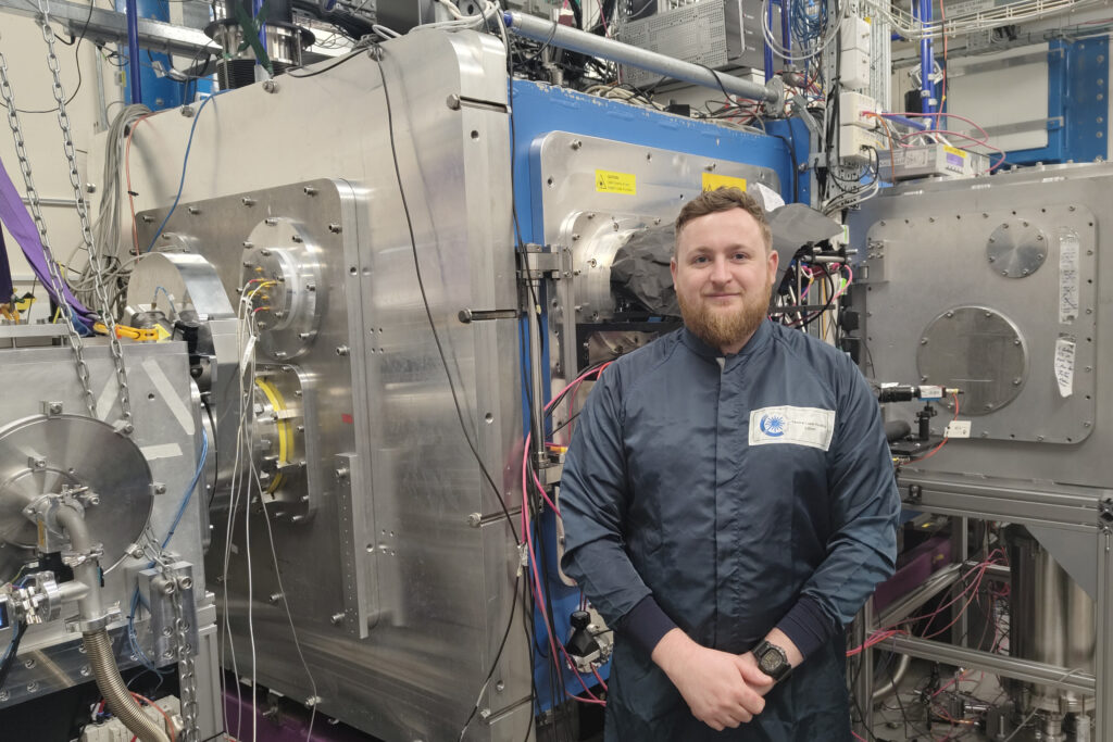 A person posing for a photo in a lab.