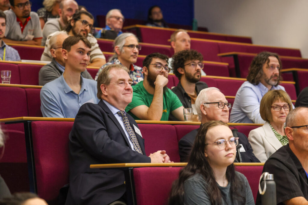 A group of people sitting in a lecture hall.
