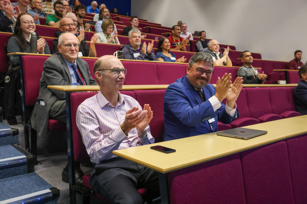 A group of people applauding.