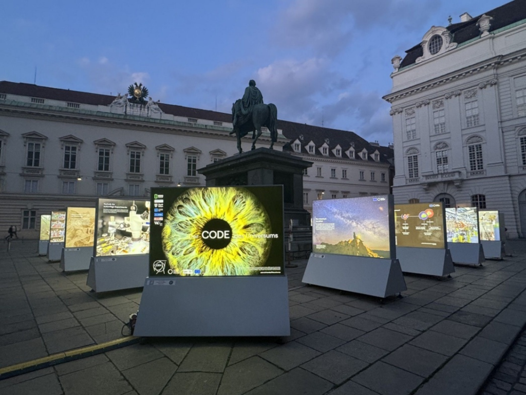 An exhibition with images, well lit. An image of and iris prominently in the middle.