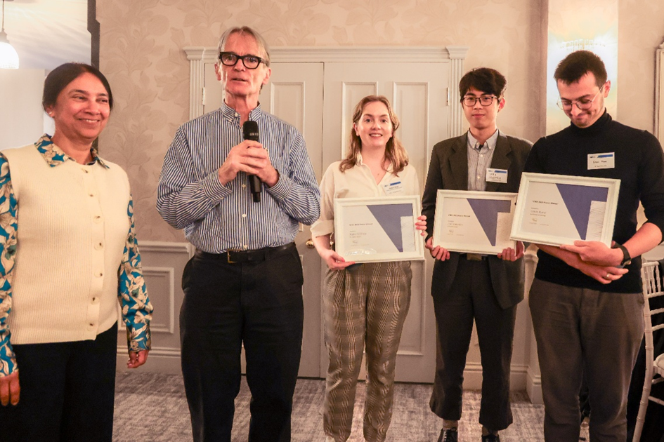 The poster prize winners and the workshop co-chairs are posing for a picture. The prize winners are holding a certificate.