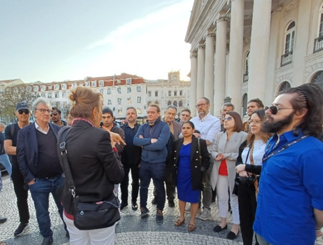 A person explaining something to a group of people.