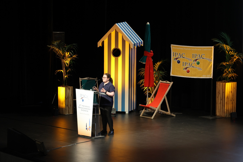 A person behind a lectern presenting a talk.
